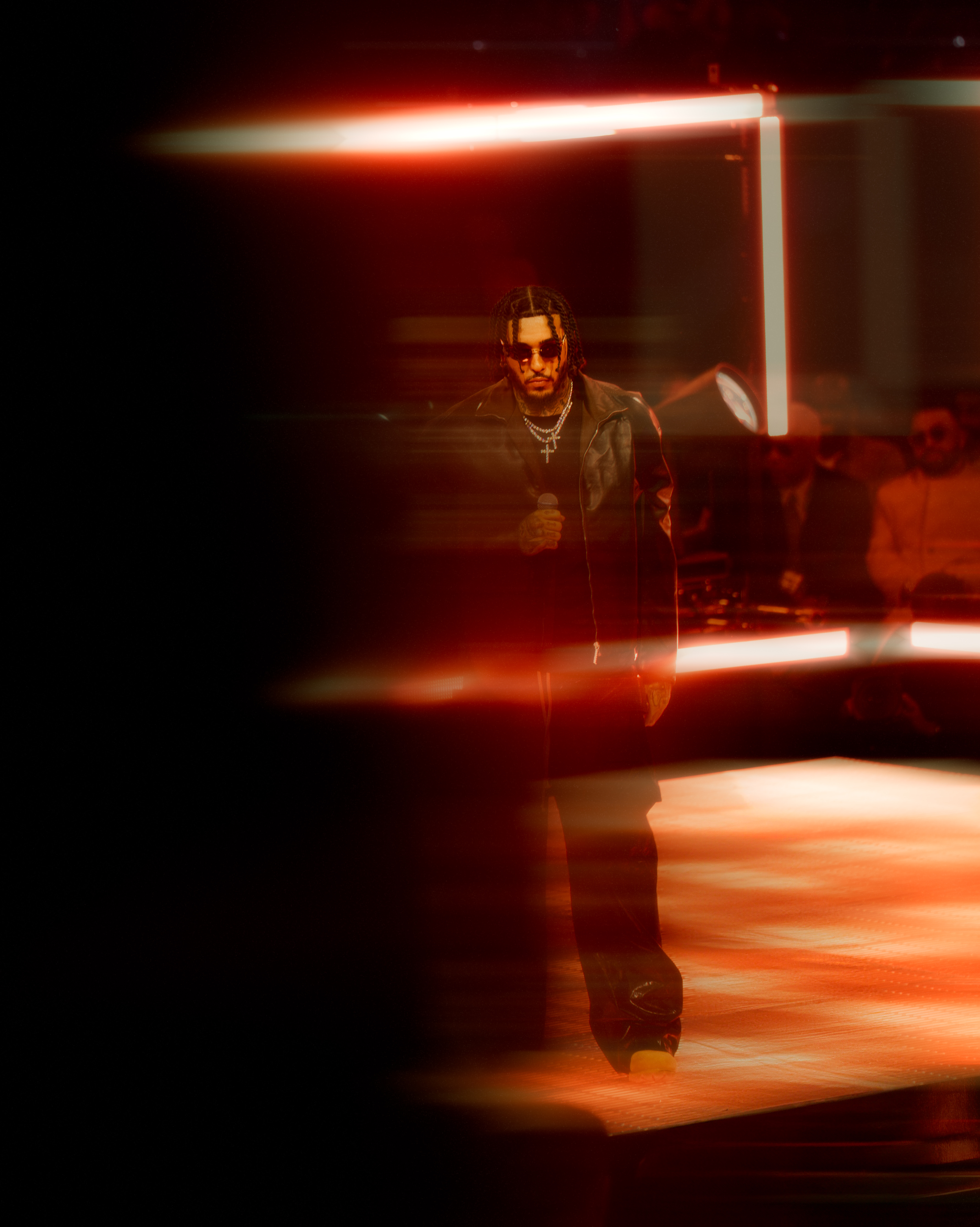 Performer silhouetted in dramatic red stage lighting at the 2025 NBA All-Star Weekend at Chase Center